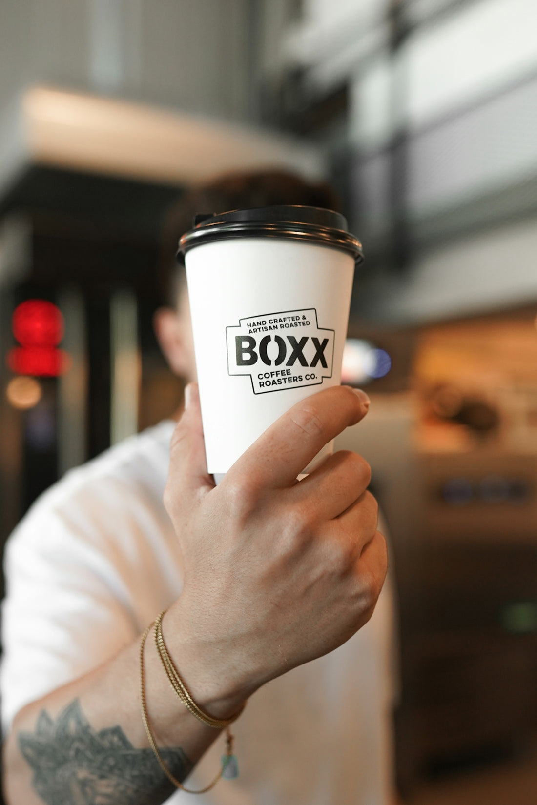 A man holding a cup of coffee in his hand