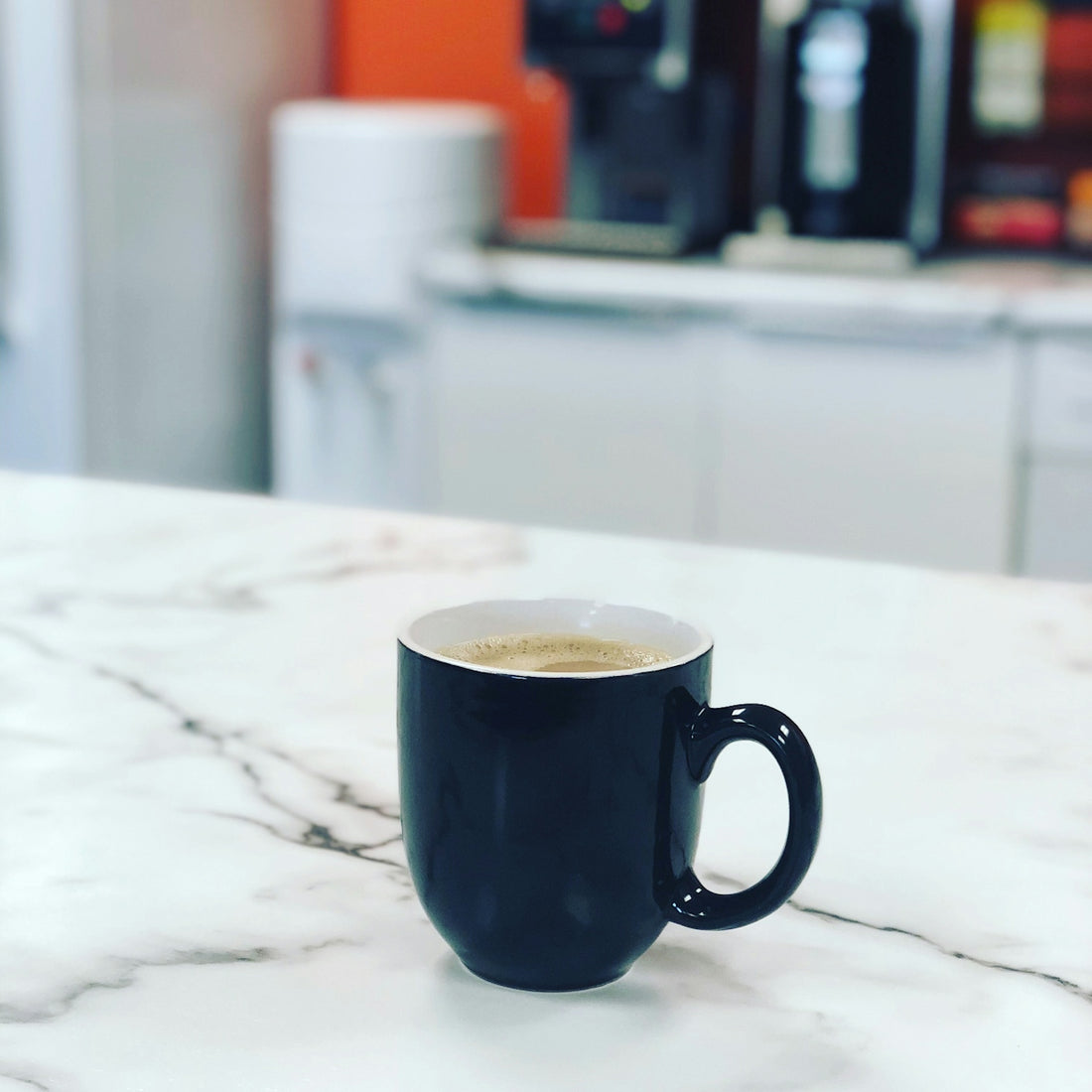 black ceramic mug on white table