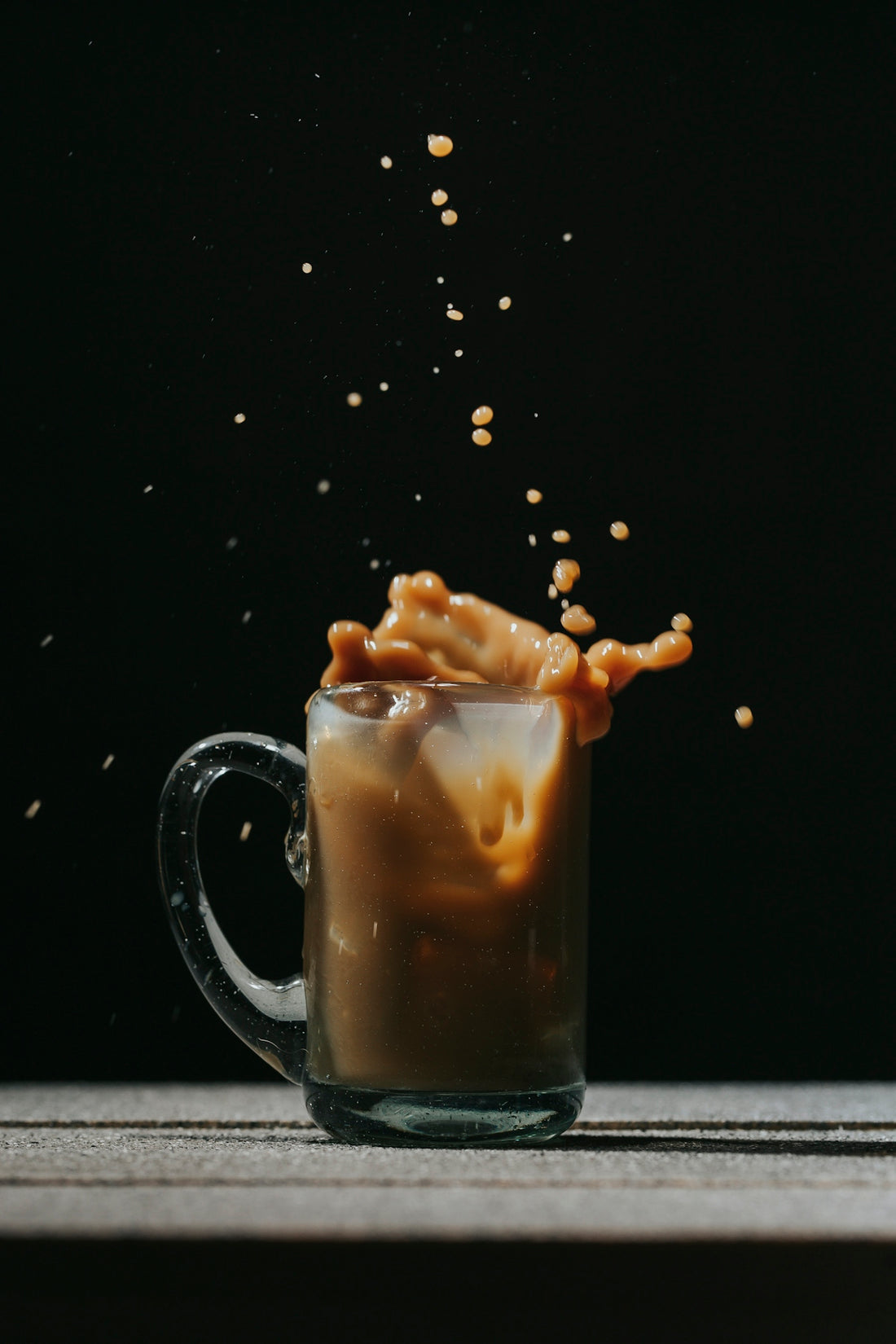clear glass mug with coffee beans