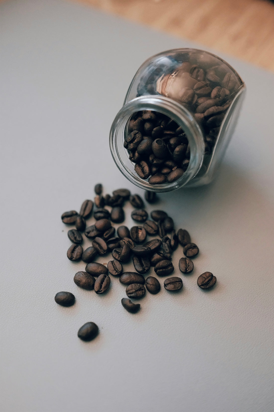 black coffee beans in clear glass jar