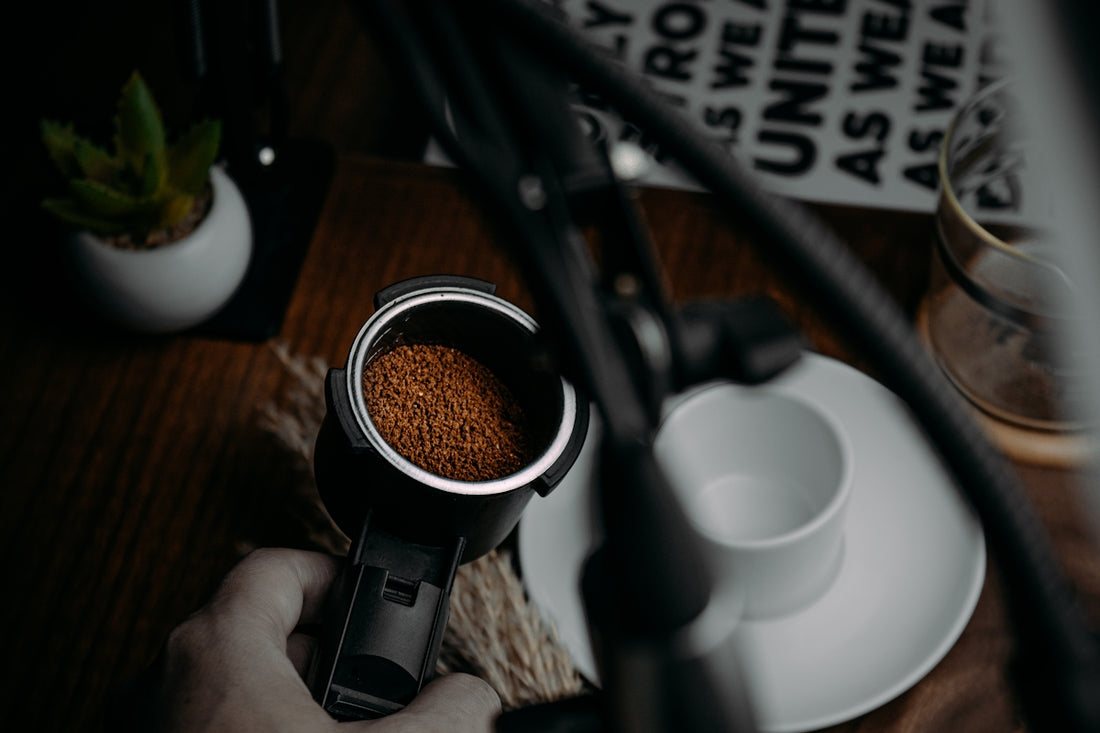 person holding black and white ceramic mug with coffee
