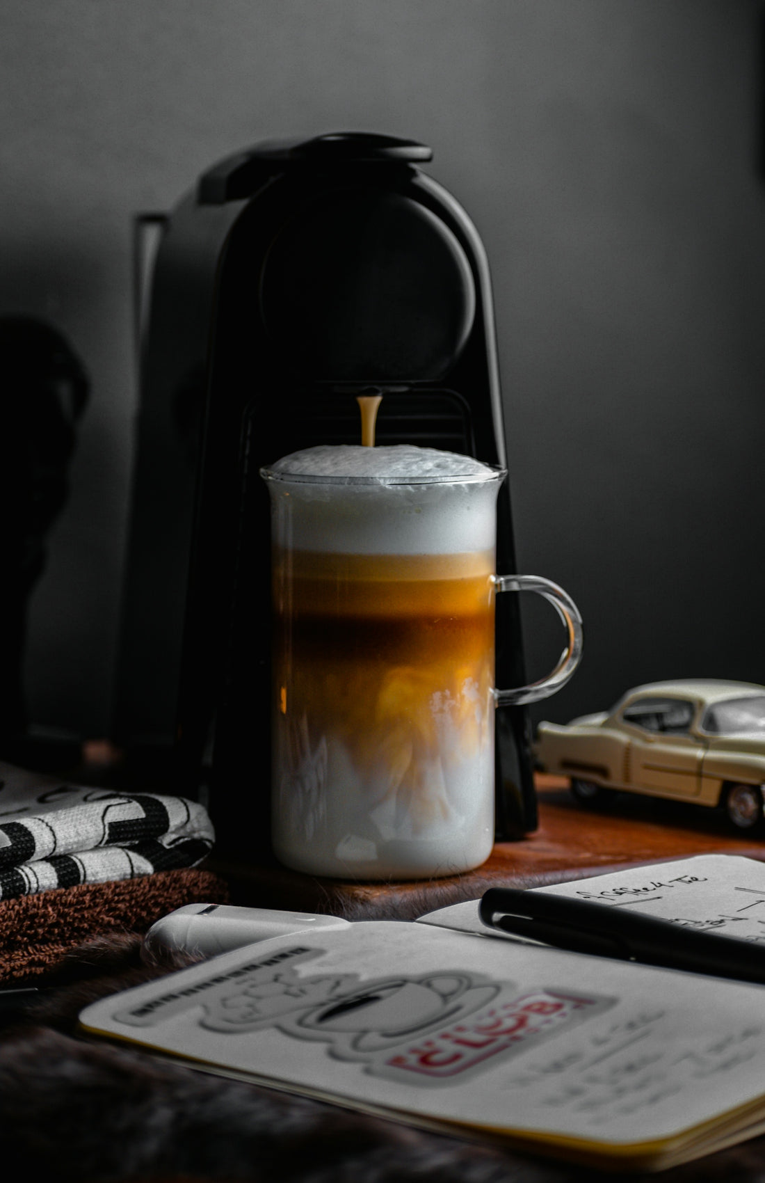 a cup of coffee sitting on top of a wooden table