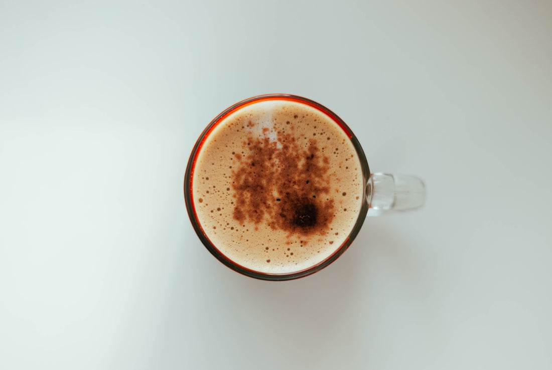 a cup of coffee with a brown substance in it