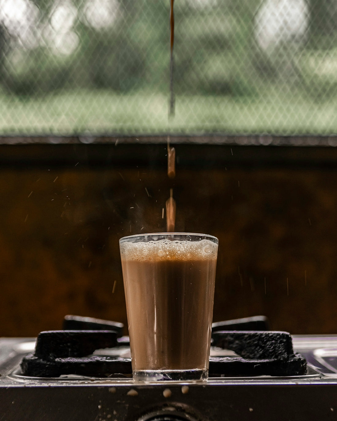 a glass of liquid on a table