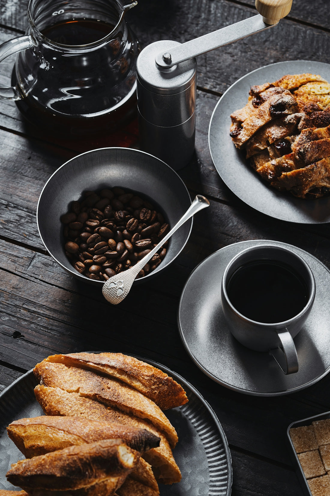 a table topped with plates of food and a cup of coffee