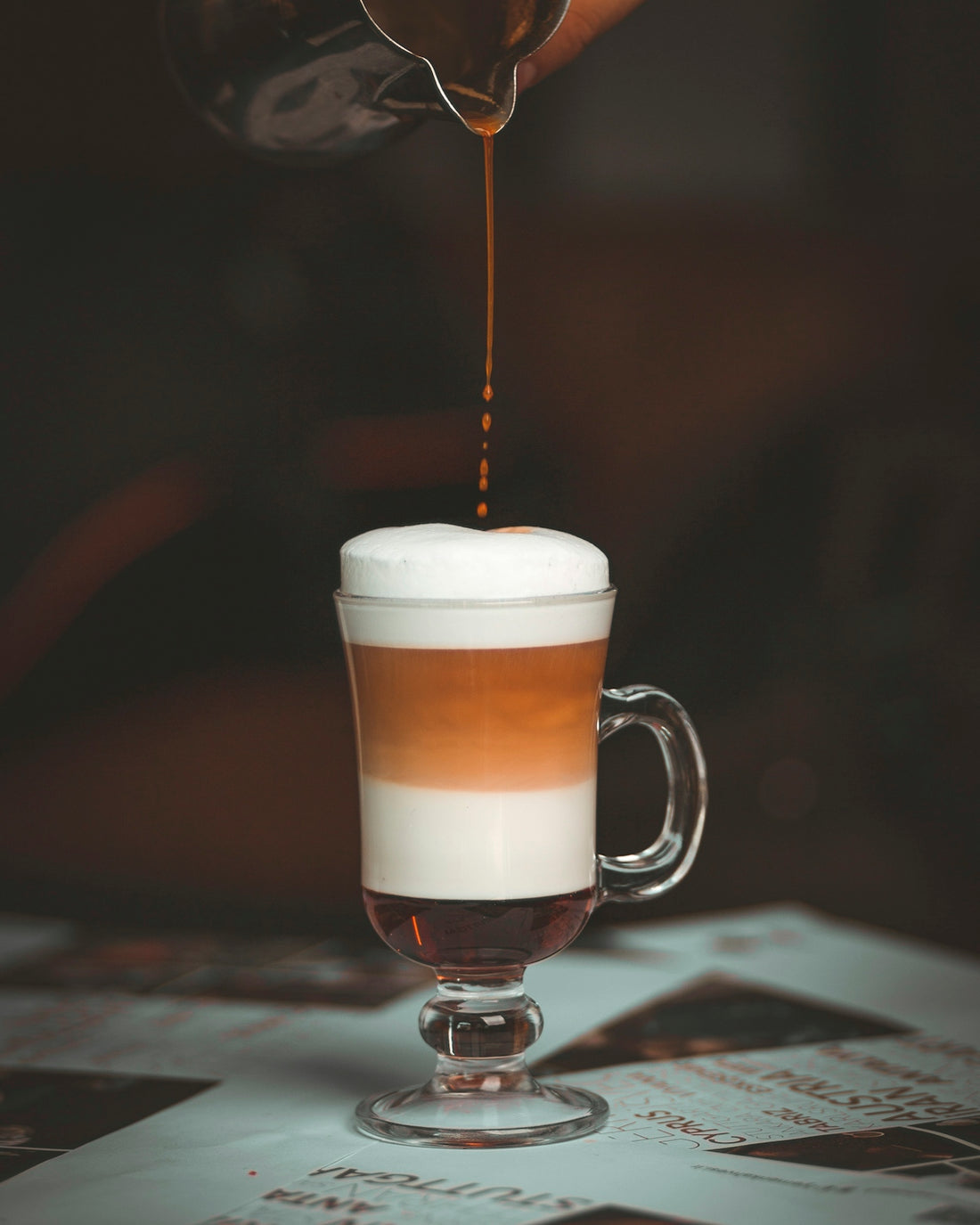a cup of coffee being poured into it