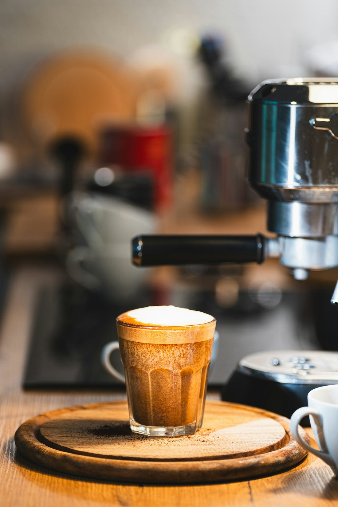 a cup of coffee sitting on top of a wooden table
