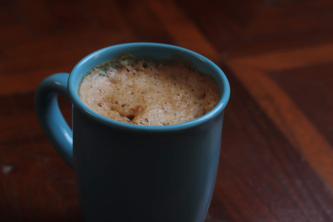A cup of coffee sitting on top of a wooden table