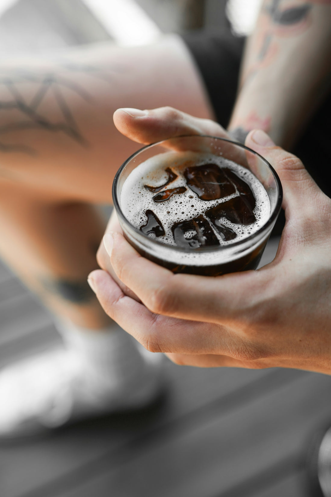 A person holding a drink in their hand