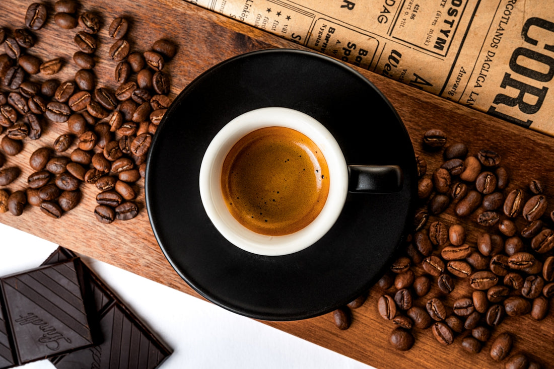 Fresh espresso with coffee beans and chocolate.
