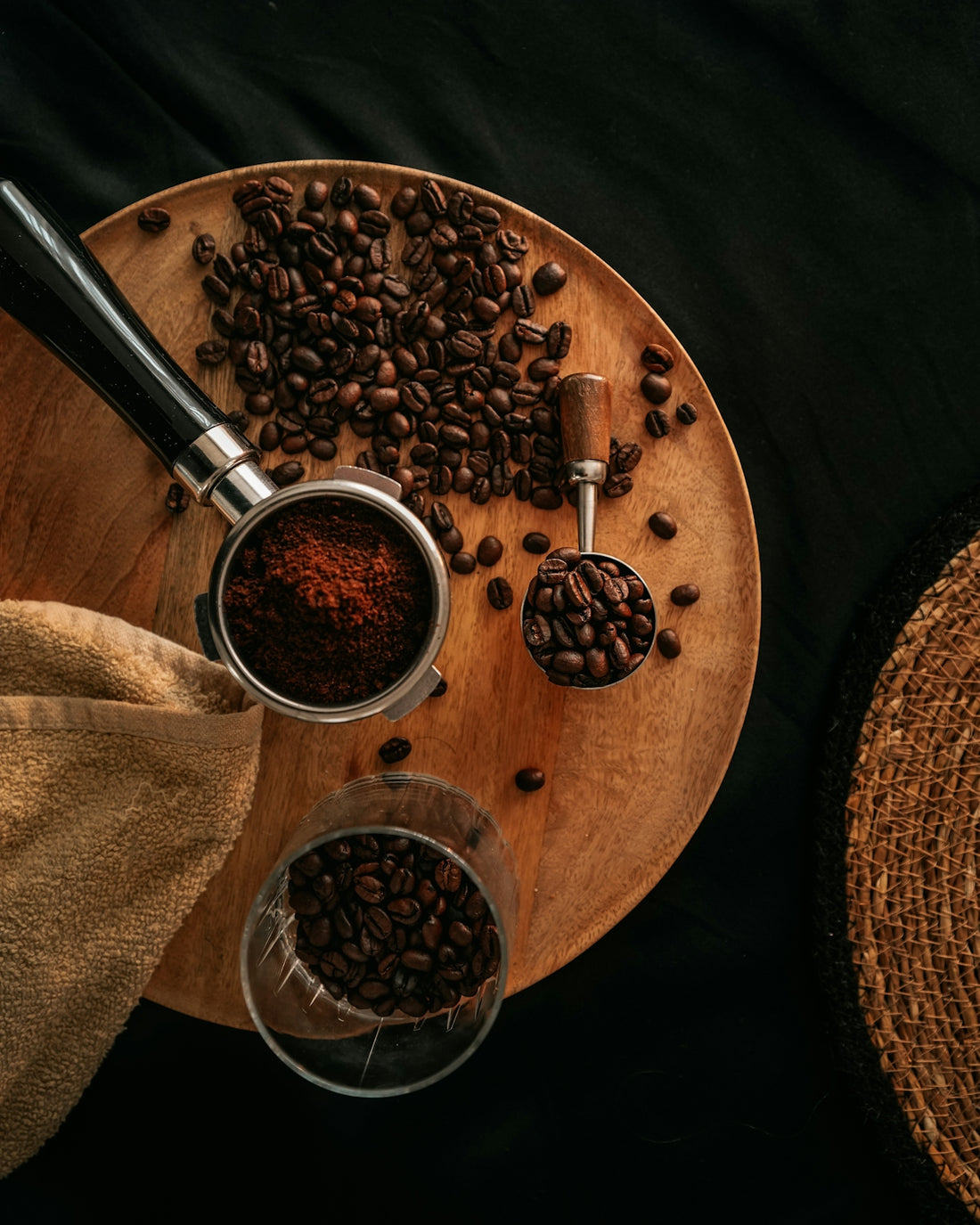 Coffee beans and grounds on a wooden board.